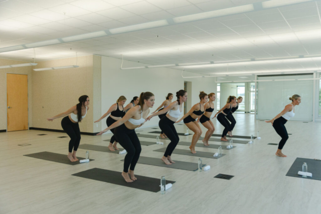 women doing yoga in bright event center room